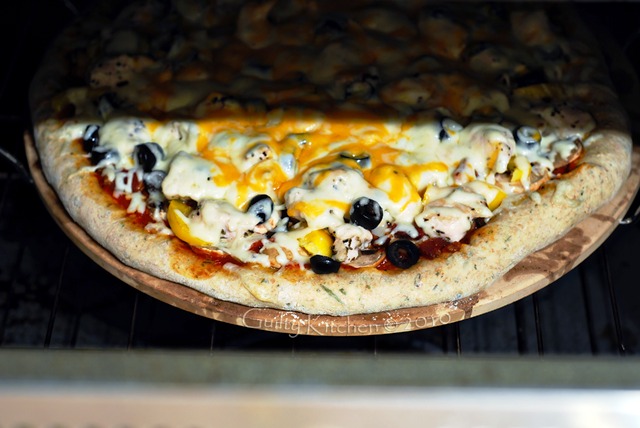 Chicken & Mushroom Pizza going into the oven on the pizza stone